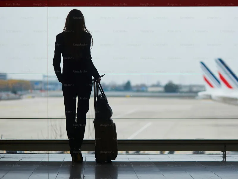 Traveler silhouette at airport terminal window waiting to fly to Costa Rica